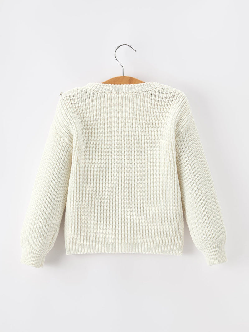 White knit sweater on a hanger against a white background