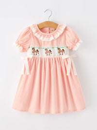Pink girls dress with puff sleeves, lace collar, smocked bodice featuring Western horse embroidery, and white lace side ties.