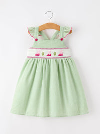 Green striped girls dress with smocked panel featuring pink boots and cactus embroidery, 100% cotton.