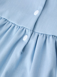 Back to School Pencil Applique Girl Dress Scallop Hem close-up of light blue fabric with white buttons.