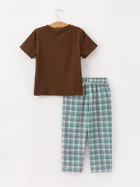 Back view of solid brown cotton t-shirt on hanger next to rear of green grey plaid pants with elastic waistband