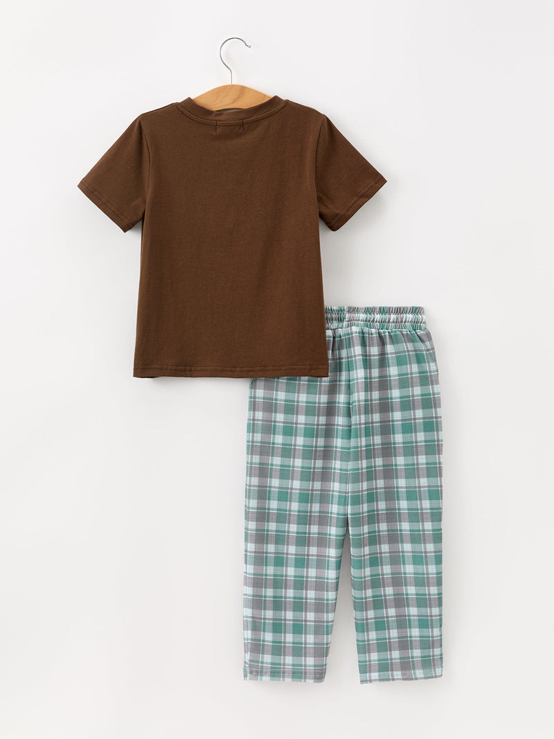 Back view of solid brown cotton t-shirt on hanger next to rear of green grey plaid pants with elastic waistband