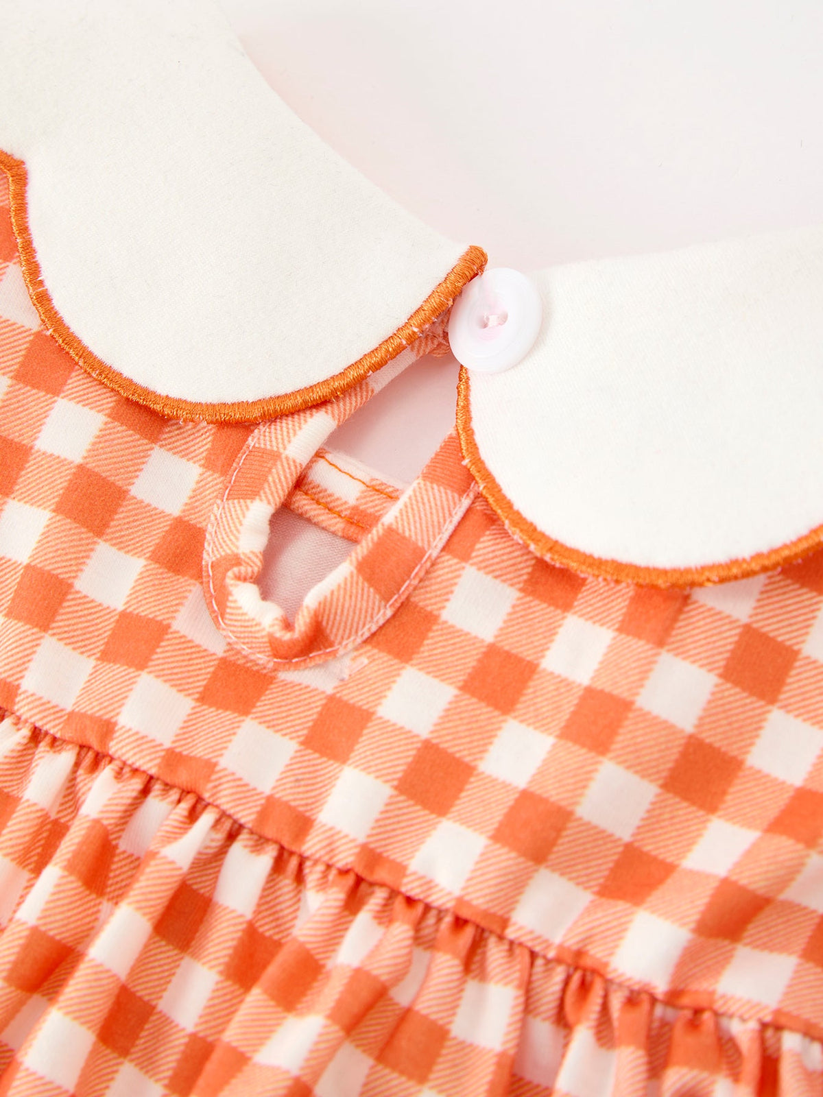 Orange gingham girls bloomers set with white scalloped Peter Pan collar, orange piping, and front button closure for Thanksgiving or Halloween.