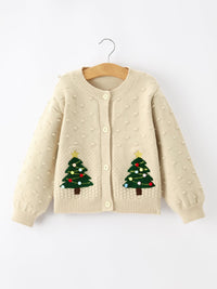 Beige kids knit cardigan with festive Christmas tree appliqués and colorful ornaments on front pockets. Button-front holiday sweater.