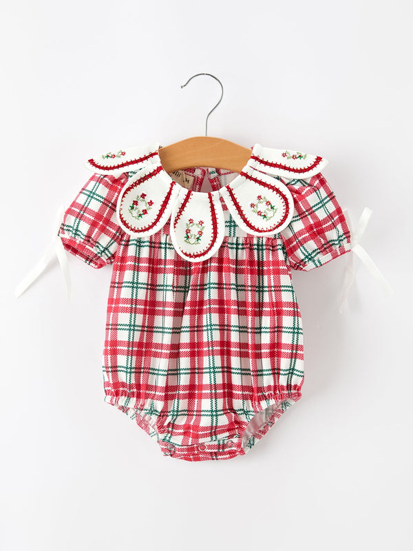 Red and green plaid bubble romper for baby girls featuring an embroidered wreath collar with holly details and puff sleeves.