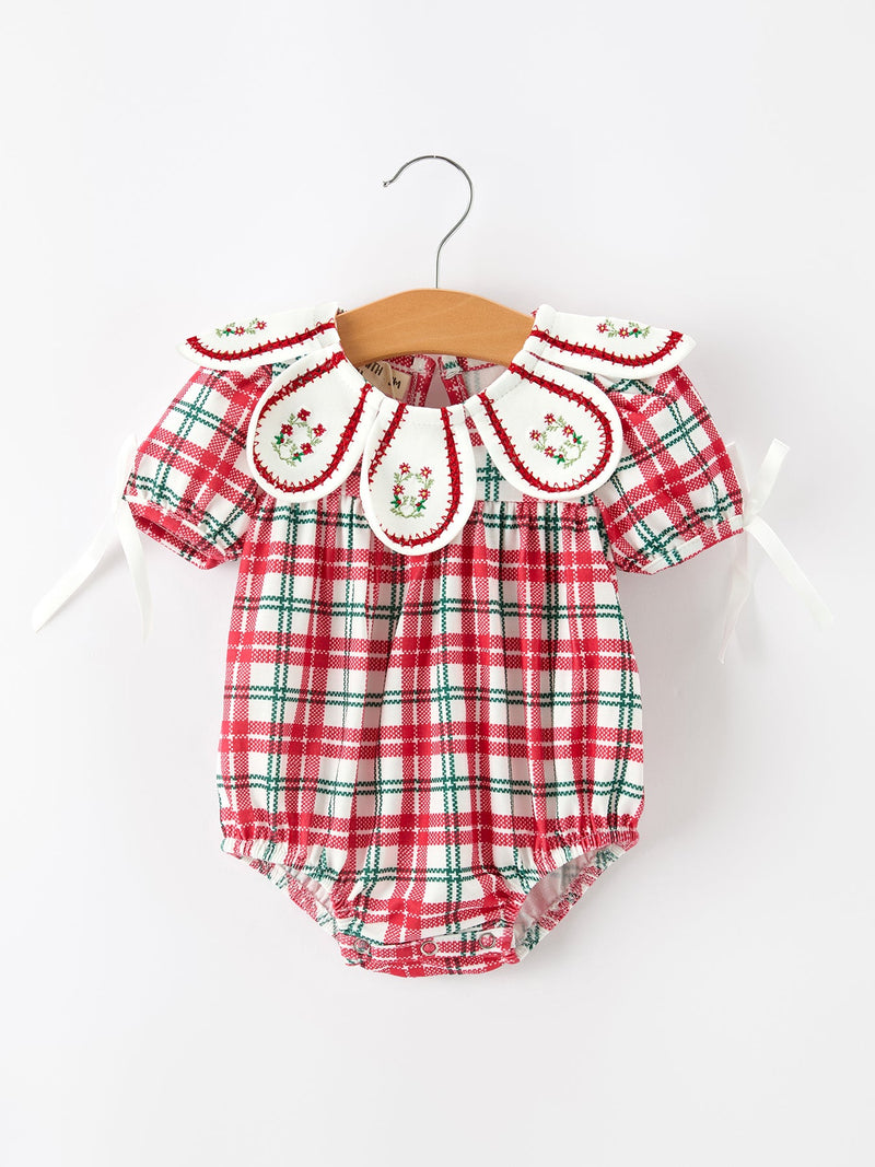 Red and green plaid bubble romper for baby girls featuring an embroidered wreath collar with holly details and puff sleeves.