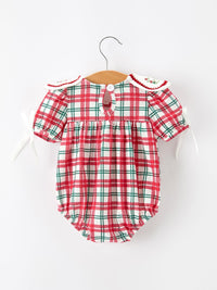 Red and green plaid baby bubble romper with embroidered wreath collar and white ribbon ties for Christmas.