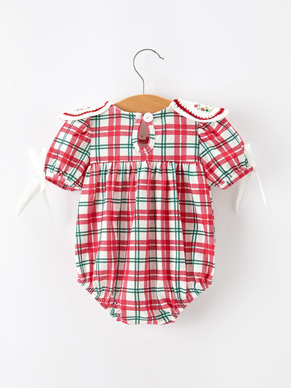 Red and green plaid baby bubble romper with embroidered wreath collar and white ribbon ties for Christmas.