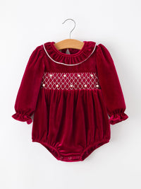 Burgundy velvet baby bubble romper featuring pearl-embellished smocking, ruffled collar, and long puff sleeves for festive holiday wear.
