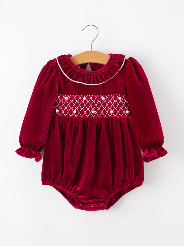 Burgundy velvet baby bubble romper featuring pearl-embellished smocking, ruffled collar, and long puff sleeves for festive holiday wear.