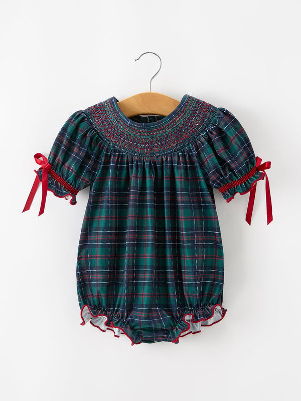 Girls Christmas plaid smocked bubble romper with green and navy pattern, puff sleeves, red ribbon ties, and ruffled leg openings.