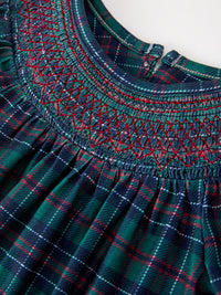 Green and navy plaid bubble romper with red diamond smocking, puff sleeves, and ruffled leg openings for girls' Christmas.