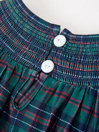 Green navy plaid girls Christmas bubble romper featuring a smocked neckline with white snap buttons and pleated fabric detail.