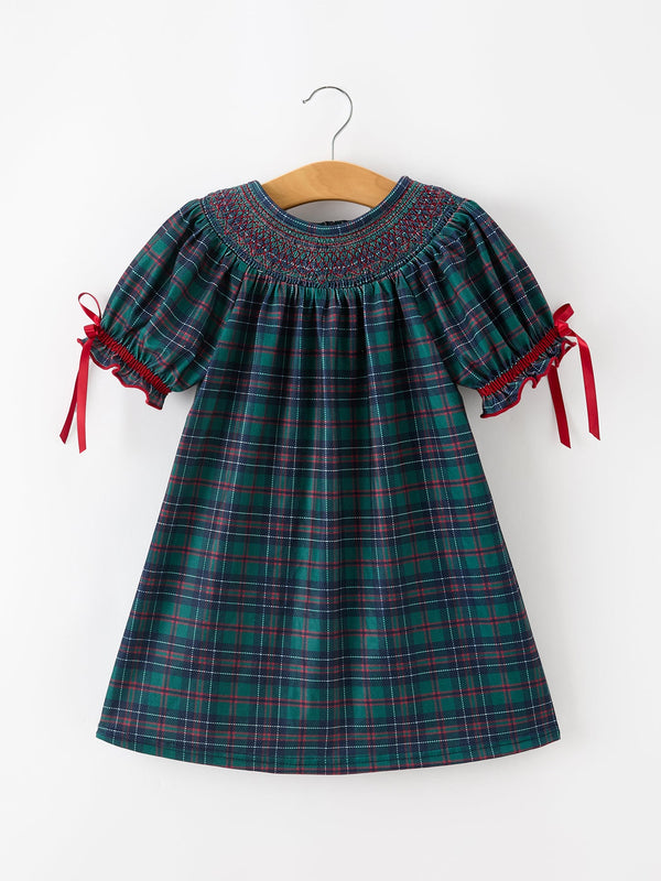 Girls green plaid smocked dress with puff sleeves, ruffled cuffs, and red ribbon ties for holiday wear.