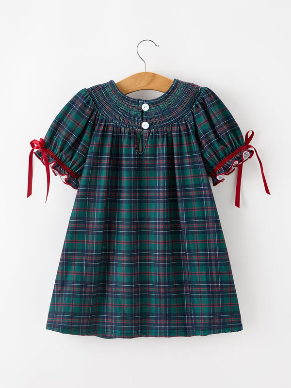 Green, navy, and red plaid girls dress with smocked yoke, puff sleeves, ruffled cuffs, and red ribbon ties.