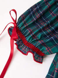 Green and navy plaid girls dress sleeve featuring puff design, ruffled cuff, and decorative red ribbon tie.