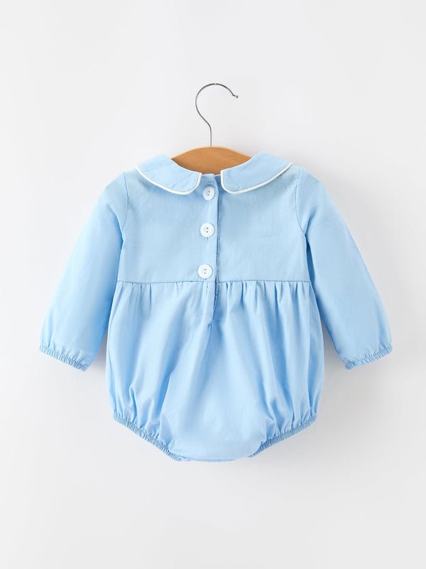 Blue baby boy cotton romper back view with Peter Pan collar, white buttons, and smocked chest panel for Christmas.