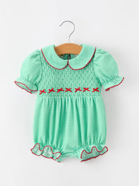 Green plaid bubble romper with smocked bodice, red cross-stitch details, Peter Pan collar, and ruffled legs for festive holiday wear.