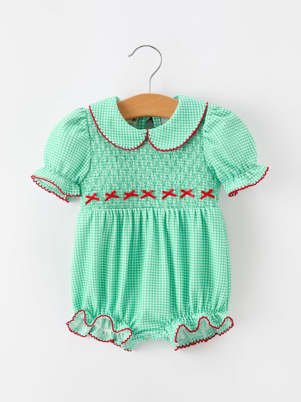 Green plaid bubble romper with smocked bodice, red cross-stitch details, Peter Pan collar, and ruffled legs for festive holiday wear.