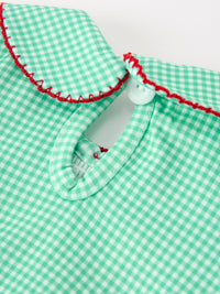Green plaid girls romper with red embroidered Peter Pan collar, smocked bodice, and white snap button for festive holiday wear.