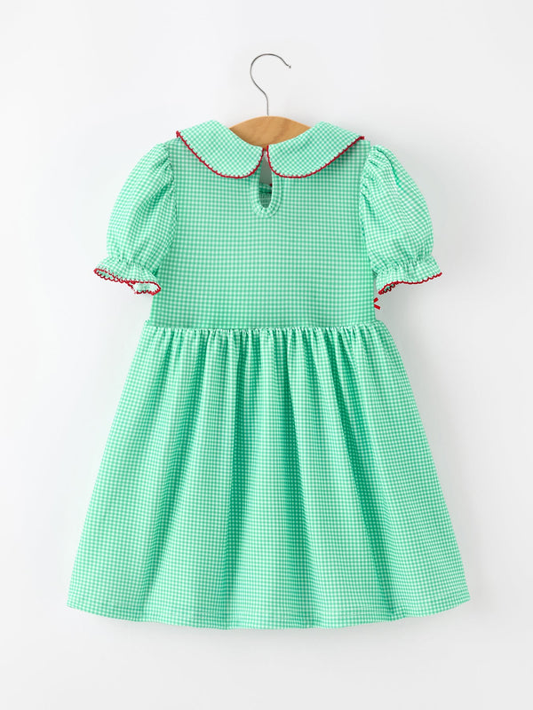 Green gingham girls Christmas dress with red-trimmed Peter Pan collar, puff sleeves, and smocked bodice.
