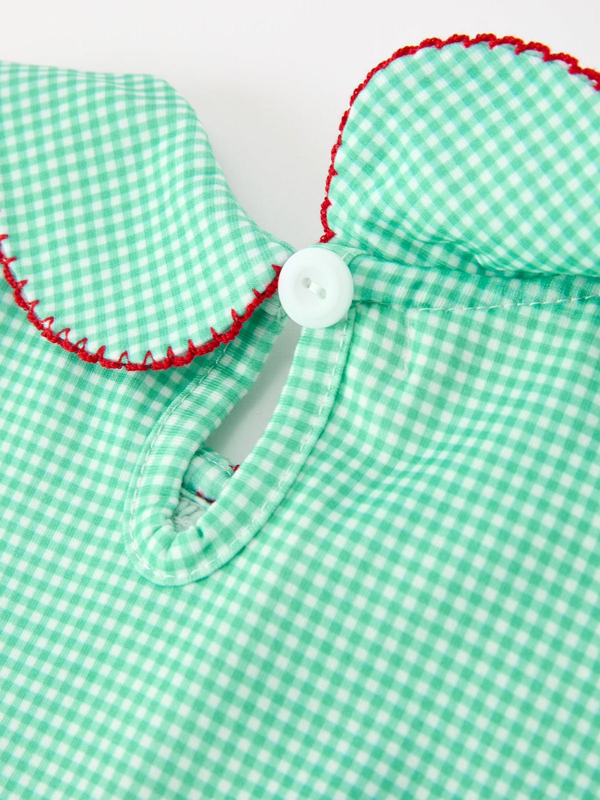 Green gingham dress collar with red trim, featuring a white button closure and vintage Peter Pan style for girls.