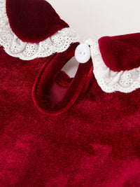 Burgundy velvet baby romper featuring a lace-trimmed Peter Pan collar and white button closure for festive holiday wear.