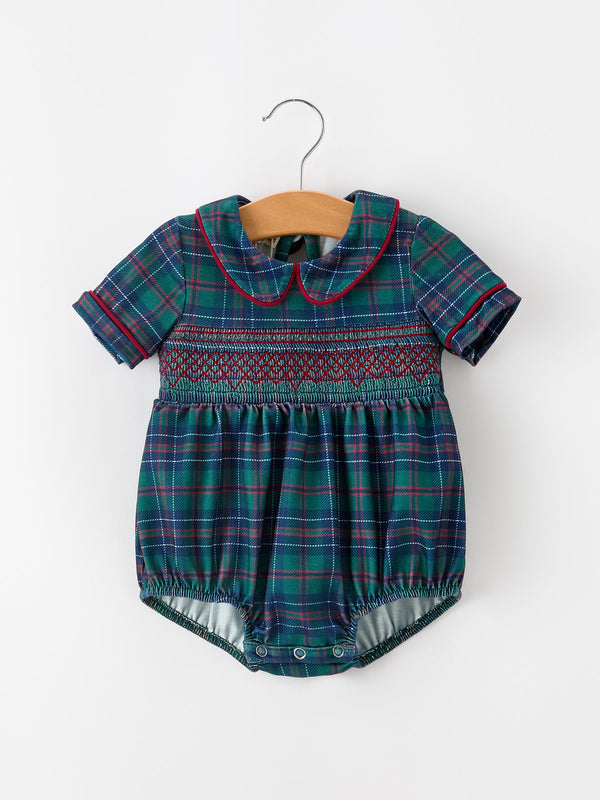 Green and blue plaid baby boy bubble romper with smocked chest, Peter Pan collar featuring red piping, and short sleeves.