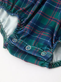 Green and navy plaid baby bubble romper featuring bottom snap closures and a softly gathered silhouette for festive style.