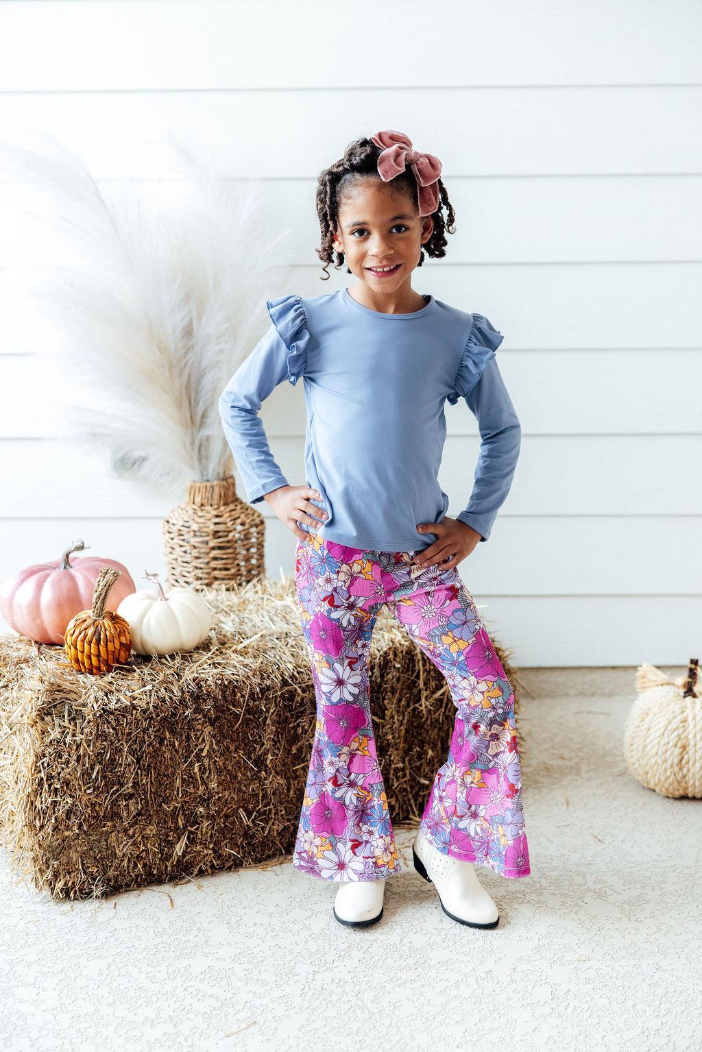 Mauve What's Up Buttercup Ribbed Velvet Bells styled with a ruffle tee on a young girl, posing with autumn decorations.