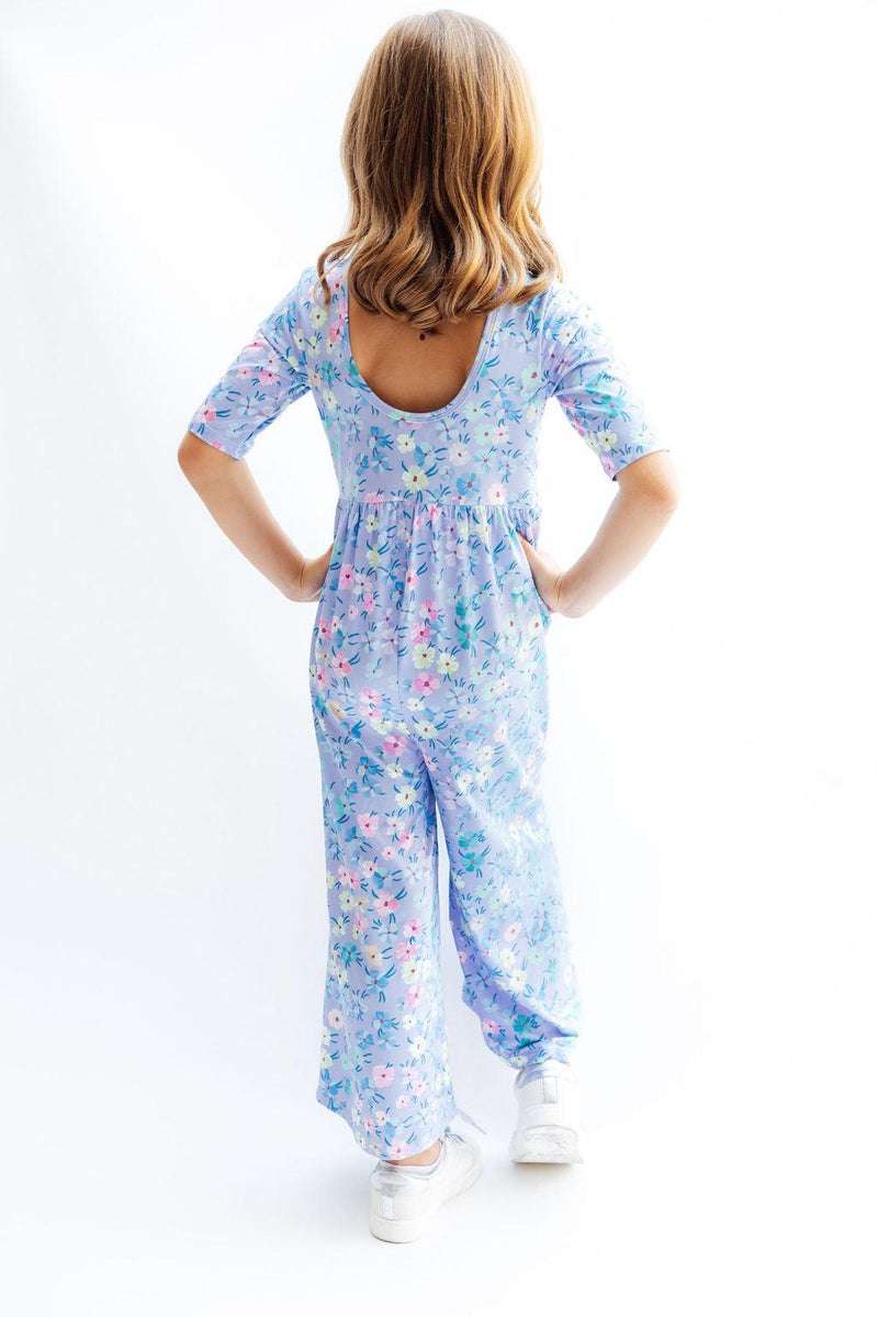 Back view of the Petal Party Wide Leg Jumpsuit, showcasing its scoop back design and wide legs, ideal for young girls who love comfort and style.