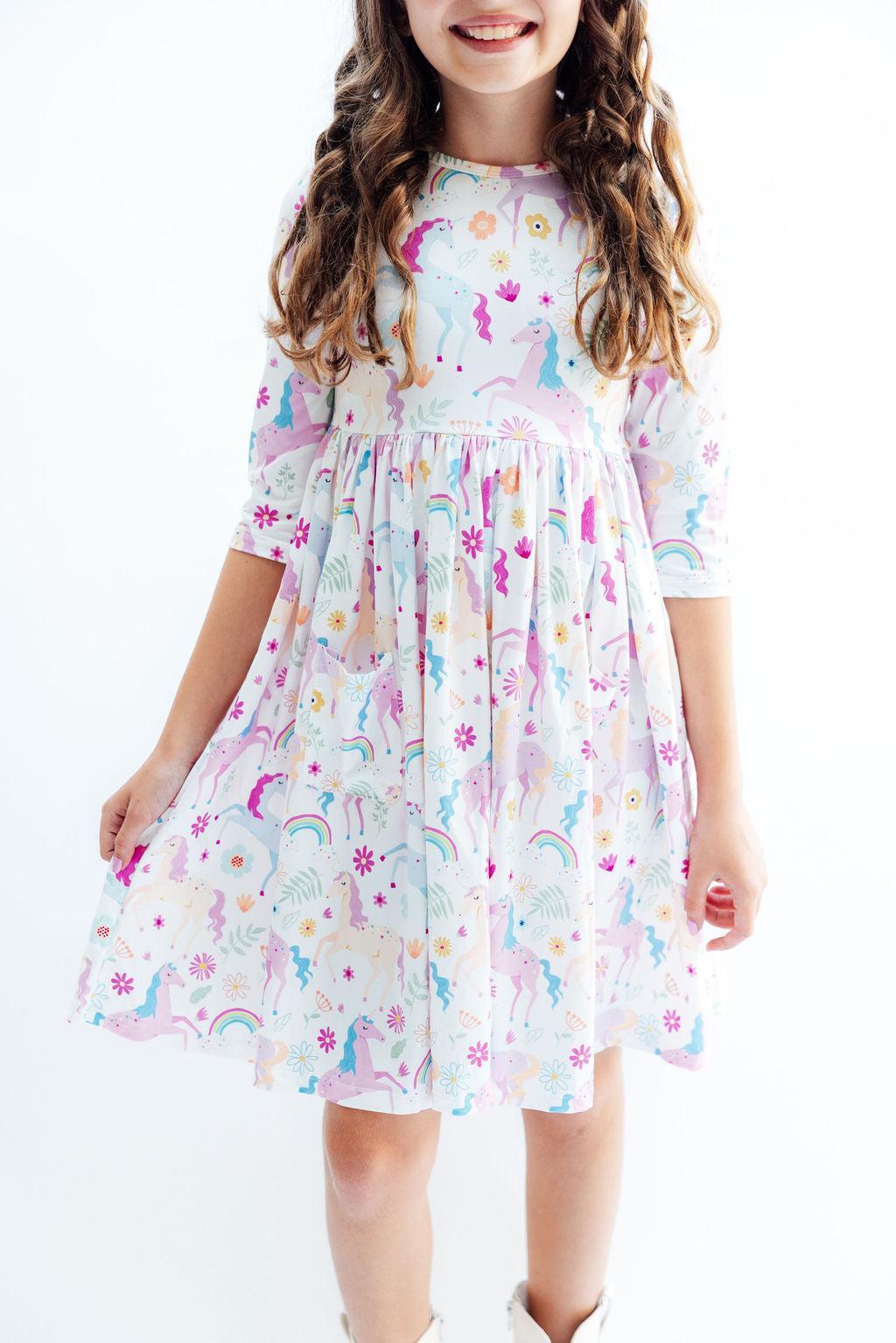 Colorful Rainbow Vibes 3/4 Sleeve Pocket Twirl Dress for Stylish Kids, featuring a playful unicorn and floral pattern, perfect for twirling and fun adventures.