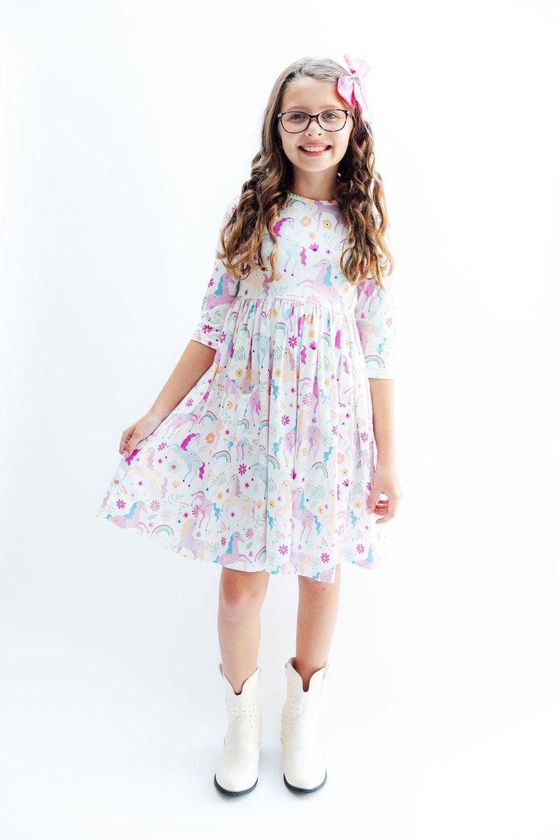 Charming Rainbow Vibes 3/4 Sleeve Pocket Twirl Dress with a delightful unicorn print, ideal for stylish kids who love to twirl and play.