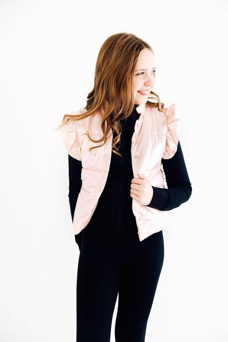 Teen wearing a trendy Light Pink Checker Puffer Vest, striking a pose with a joyful expression, perfect for chilly days out.