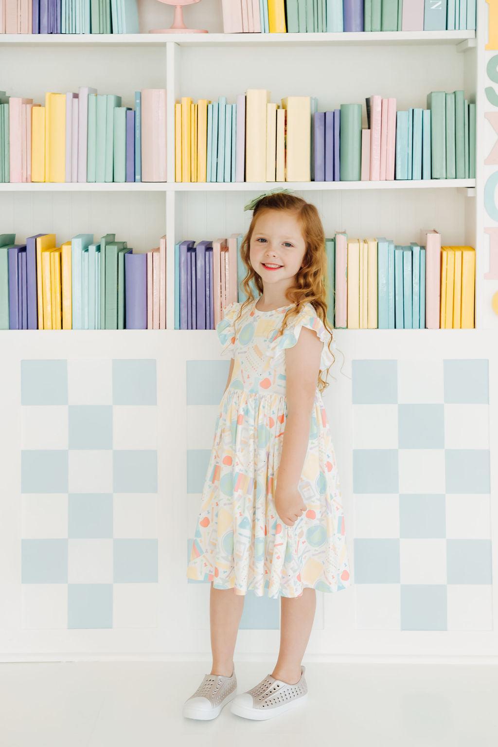 Adorable Campus Cutie Flutter Sleeve Twirl Dress for Girls showcased in a vibrant floral pattern, perfect for playful twirls.