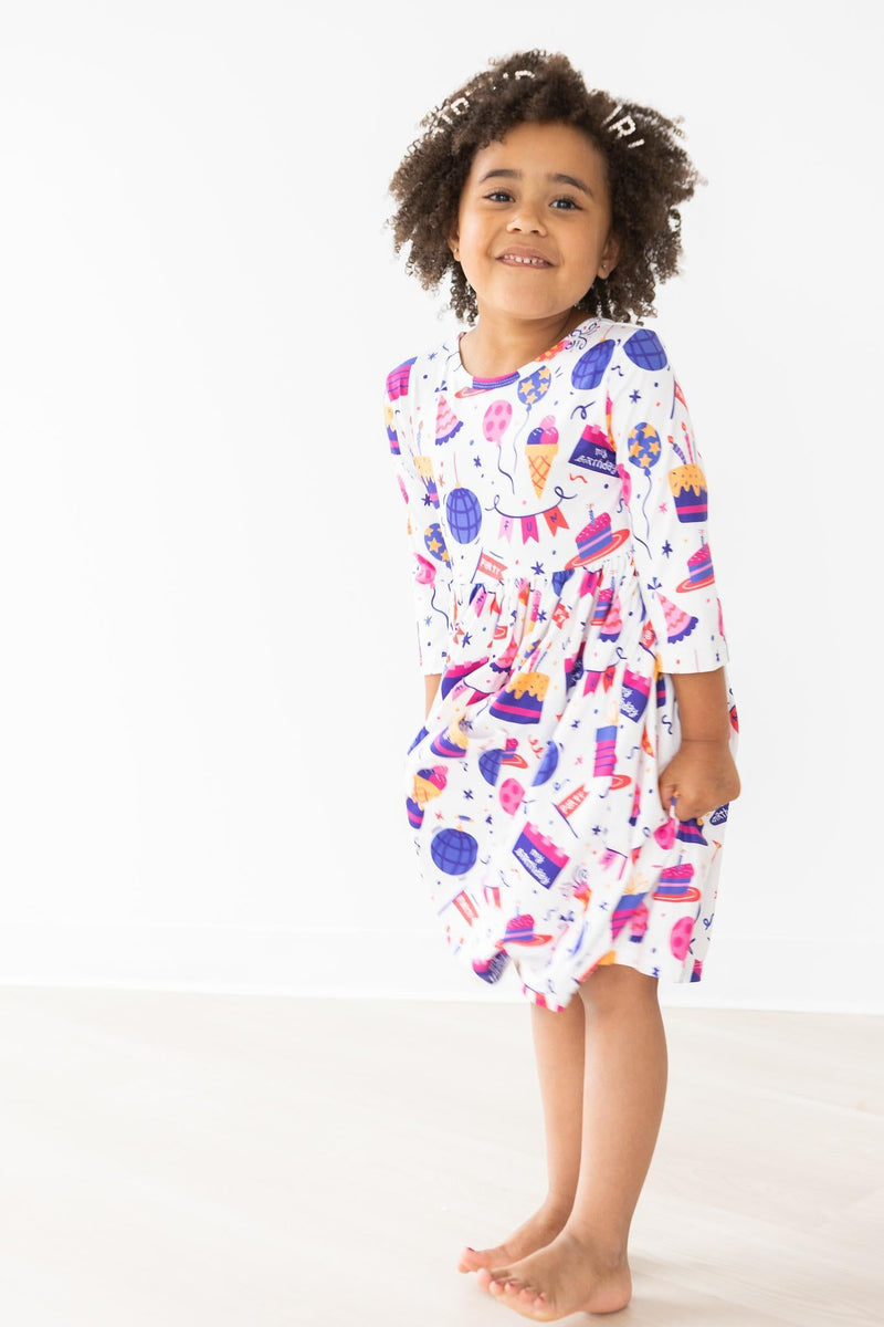Happy Birthday 3/4 Sleeve Pocket Twirl Dress on a playful girl, captured mid-twirl, embodying the spirit of a birthday party with vibrant motifs.