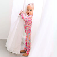 Happy baby in the Second-Skin Footless Romper | Saddle Up Western Themed, embodying comfort and cuteness in this stylish bamboo baby romper.