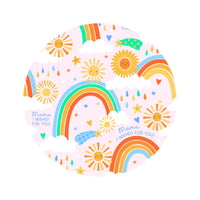The SoftKnot Bow Here Comes the Sunshine pink bamboo head-wrap bow with sun, rainbow, and clouds motif.