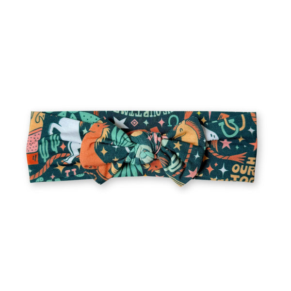 The SoftKnot Bow Wild West head-wrap bow in a colorful print, cozy, gentle knot for babies