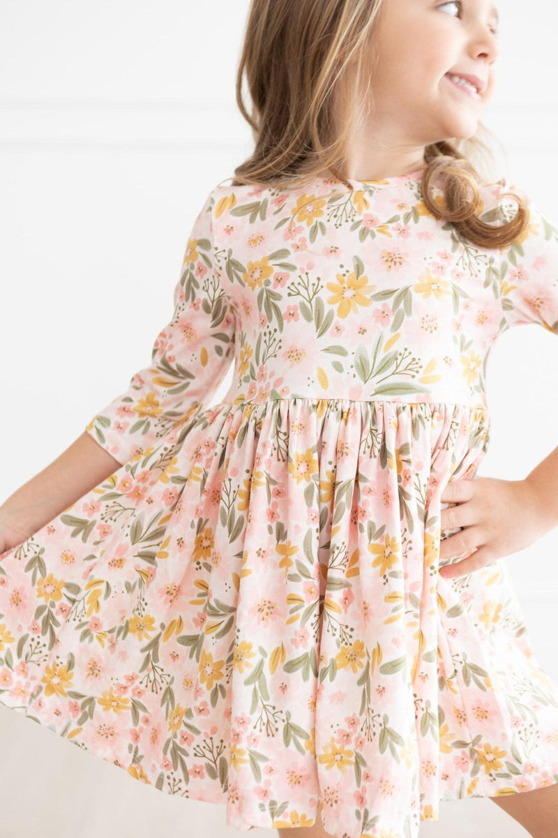 Charming close-up of a girl in the Pretty Peachy 3/4 Sleeve Pocket Twirl Dress, capturing the essence of playful elegance.