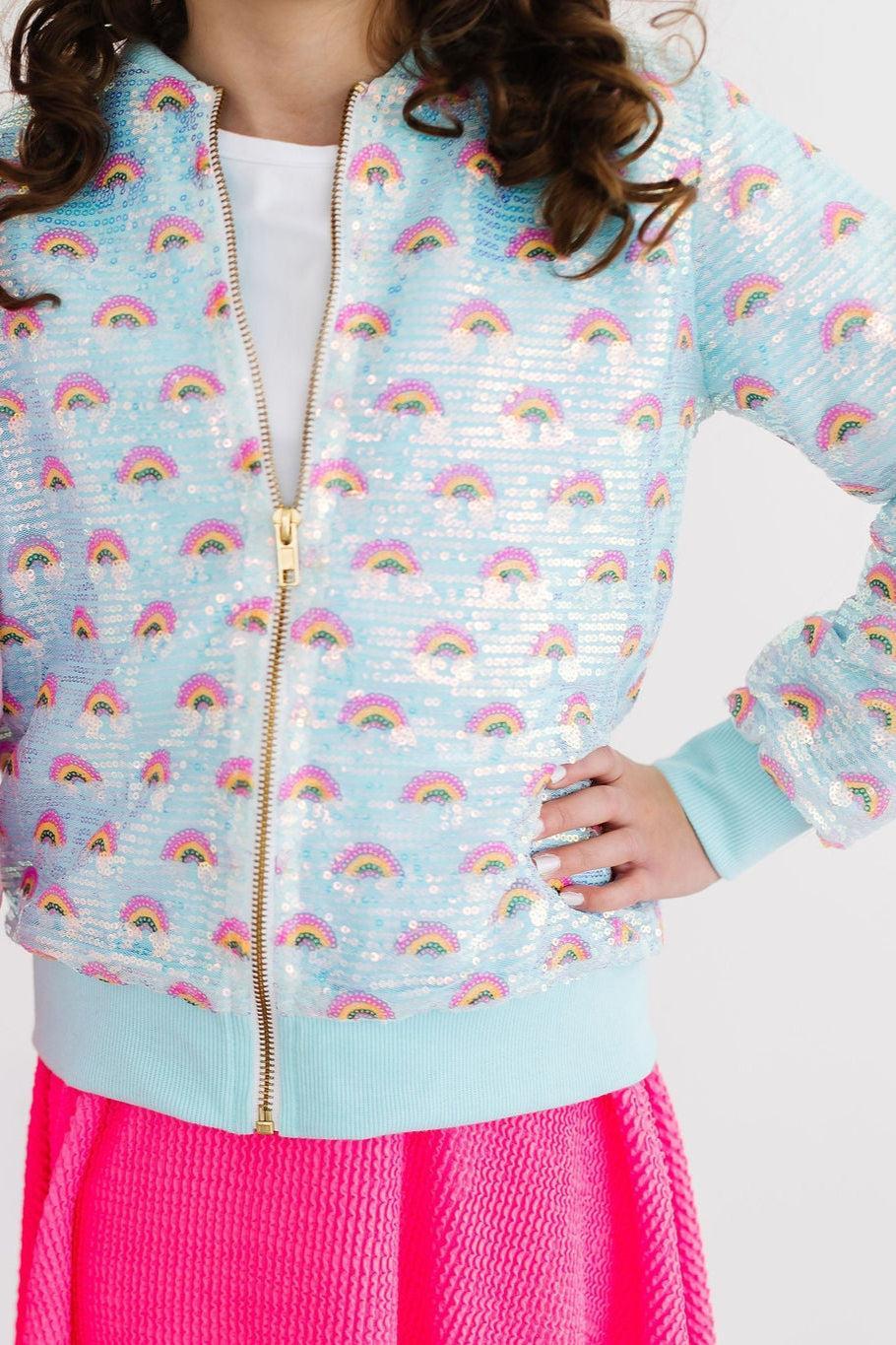 Stylish girl showcasing the Mint Rainbow Sequin Jacket, featuring colorful rainbow sequins and a playful mint hue, perfect for trendy outfits.