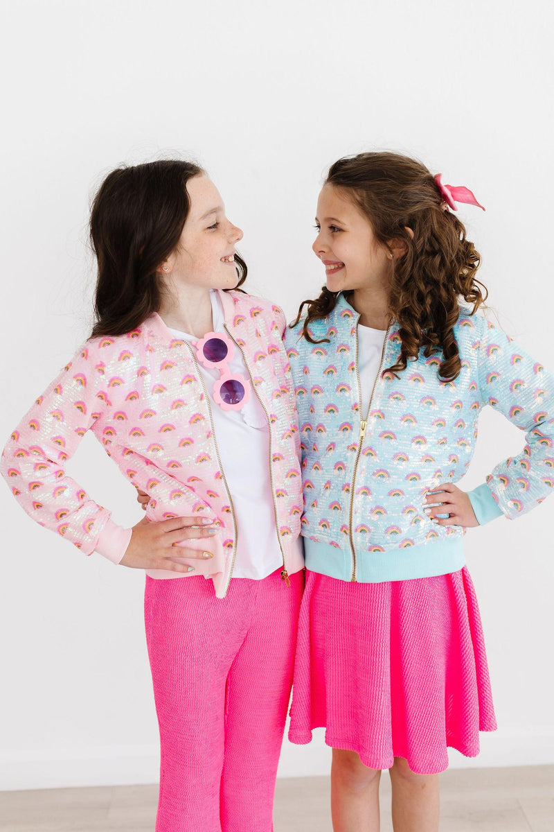 Two girls having fun in their Mint Rainbow Sequin Jackets, one in pink and the other in mint, radiating joy and style with playful designs.