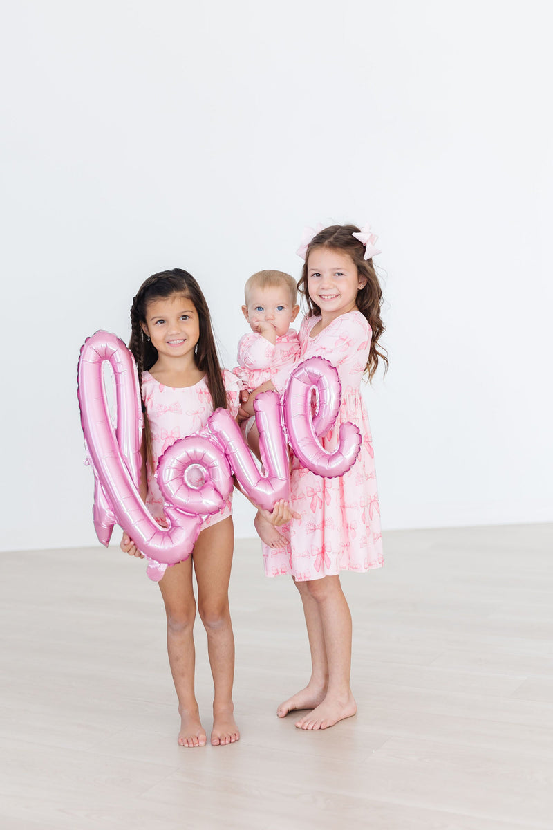 Group of girls wearing Blushing Bows 3/4 Sleeve Pocket Twirl Dress, showcasing how easily it can be paired with other styles.