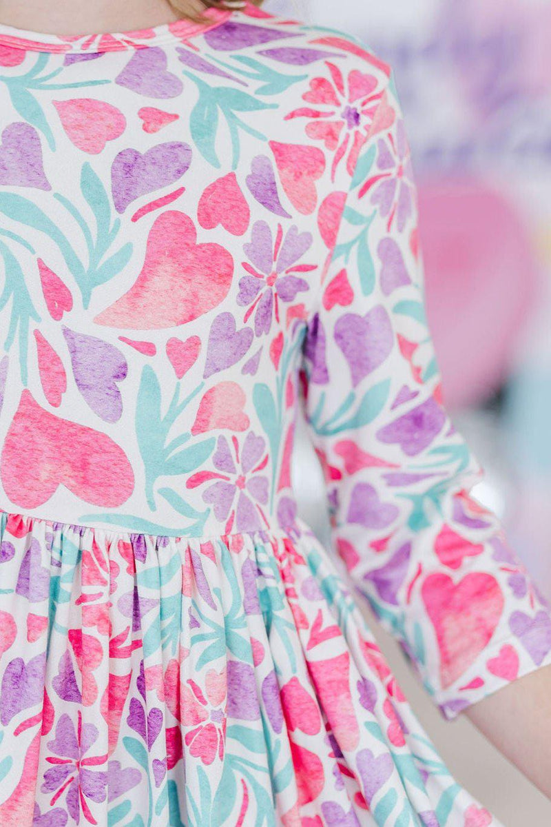 Close-up of the Watercolor Hearts 3/4 Sleeve Pocket Twirl Dress fabric featuring colorful watercolor hearts.