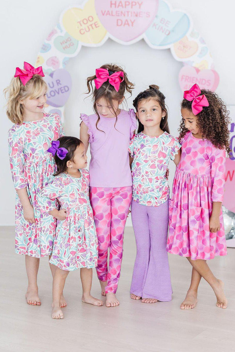 Flat lay of the Watercolor Hearts 3/4 Sleeve Pocket Twirl Dress paired with coordinating leggings.