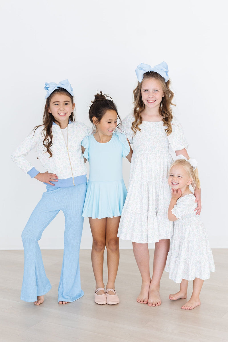 Young ballerina wearing the Bluebird S/S Twirl Leotard from Mila & Rose, twirling in a dance studio, embodying grace and joy.