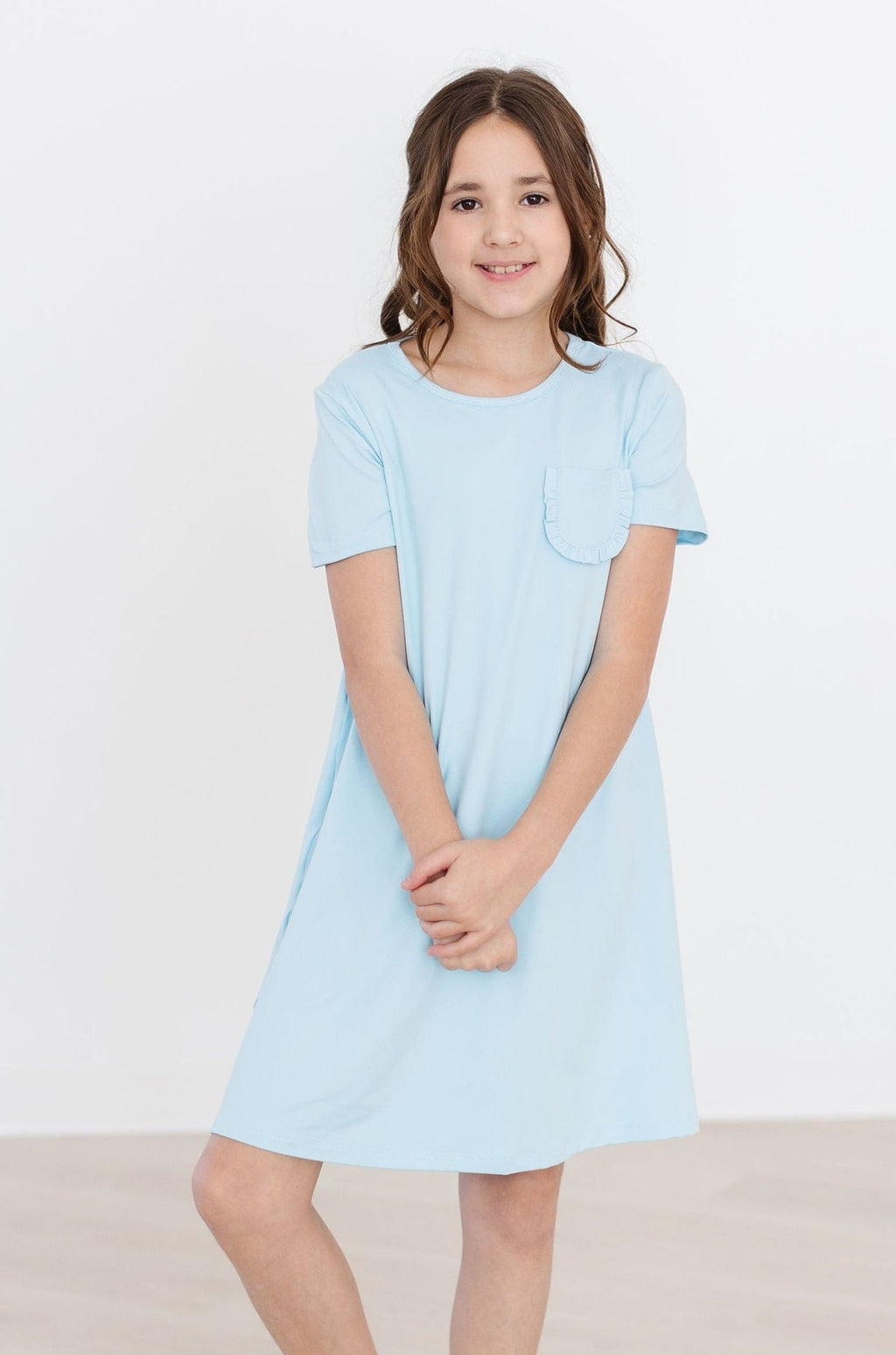 Bluebird T-Shirt Dress by Mila & Rose featuring a soft polyester-spandex blend and a cute ruffle pocket, perfect for active girls.