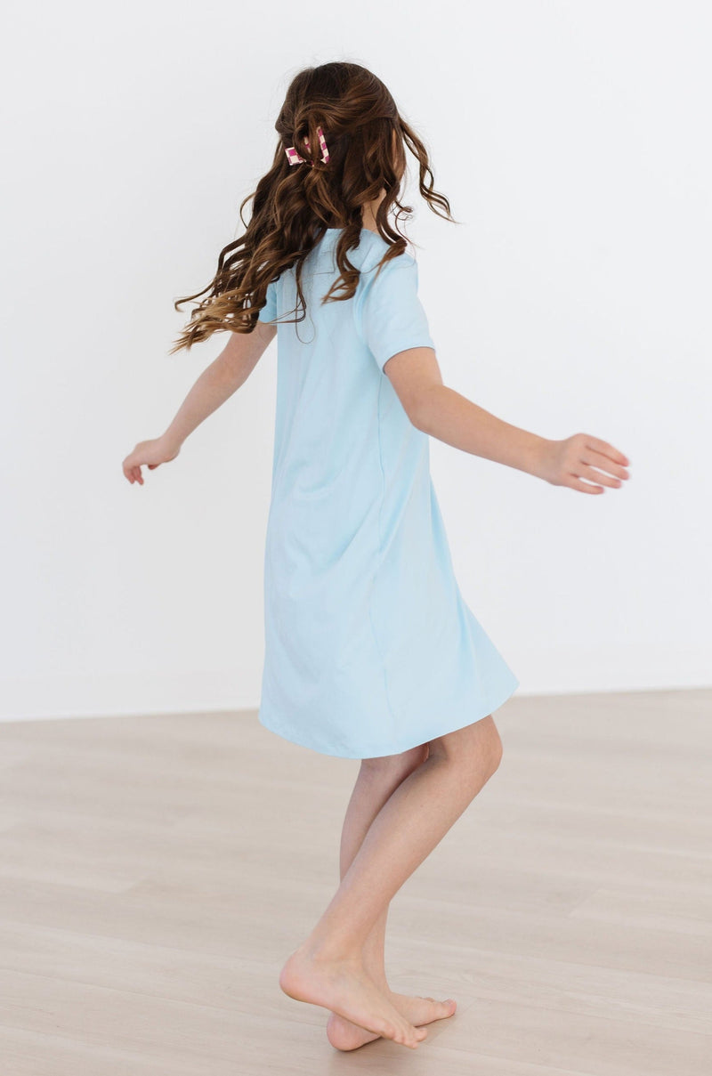 Young girl wearing the Bluebird T-Shirt Dress by Mila & Rose, enjoying her playful day at the playground.