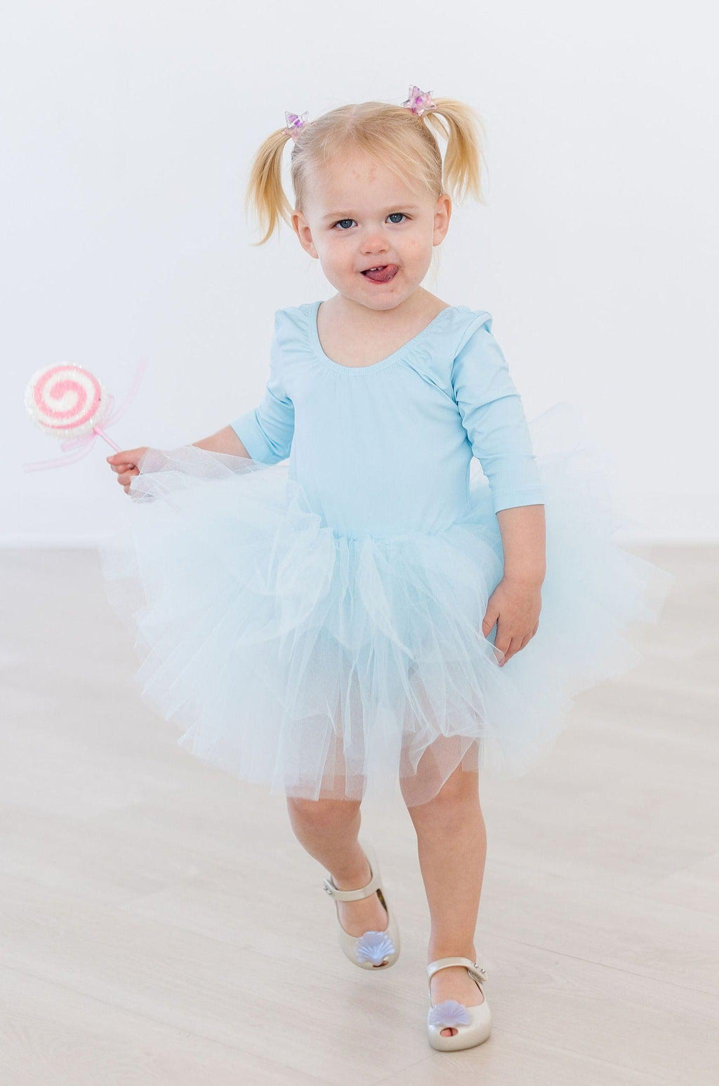 Bluebird 3/4 Tutu Leotard by Mila & Rose® worn by a little girl, showcasing its vibrant blue color and fluffy tulle layers.
