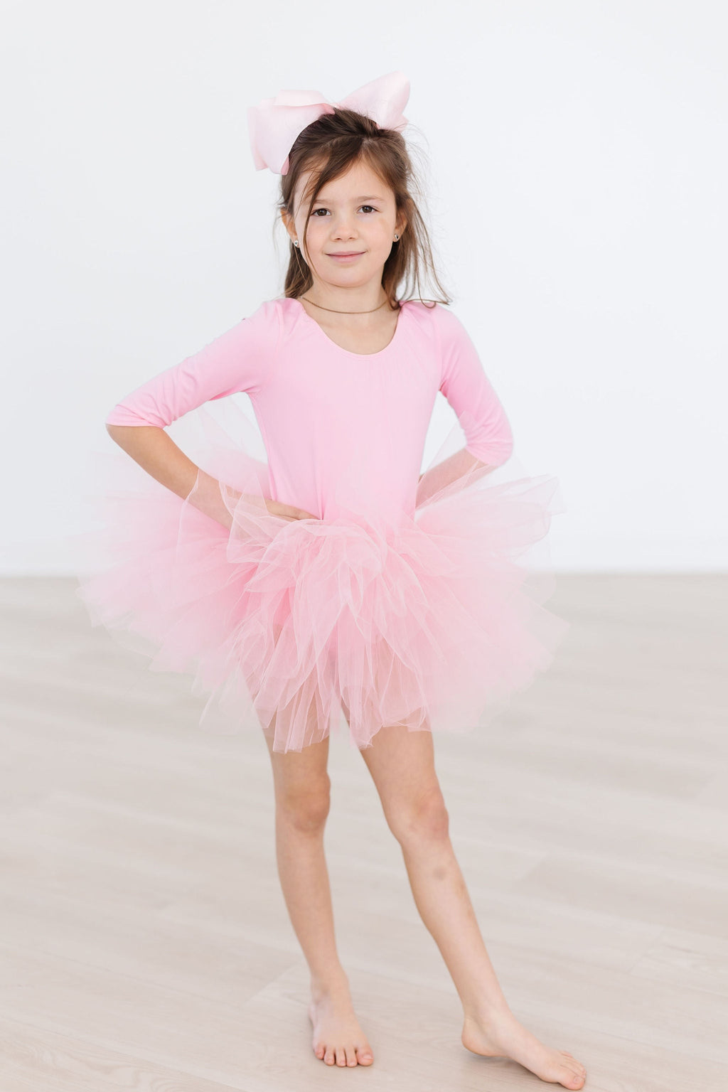 Cute child wearing Bubblegum Pink 3/4 Tutu Leotard from Mila & Rose, showcasing the fluffy layers of soft tulle.